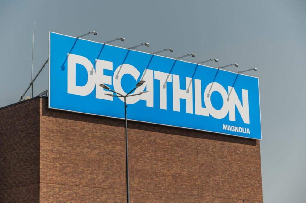 Thi công Decal quảng cáo thương hiệu Decathlon Close-up of a Decathlon store sign against a clear sky on a brick building.